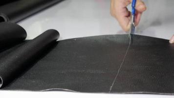 Leather tailor is working with her handmade product with black wool video