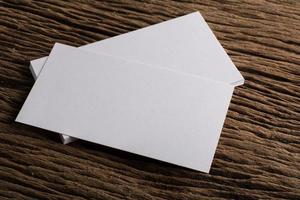 Blank white business card on wood background photo