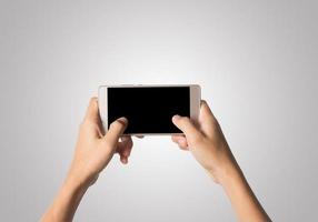 mano de mujer, tenencia, teléfono inteligente, pantalla en blanco foto