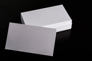 Blank white business card on wood background photo