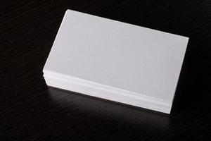 Blank white business card on wood background photo