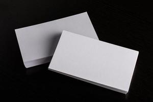 Blank white business card on wood background photo