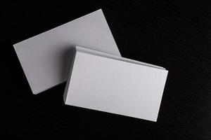 Blank white business card on wood background