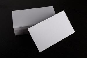 Blank white business card on wood background photo