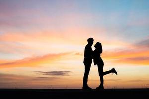 Silhouette of young couple during sunset photo
