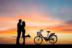 Silhouette of young couple together during sunset photo