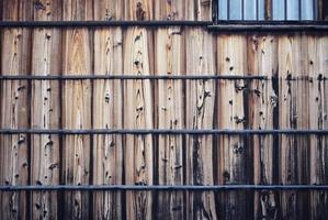 Brown wooden wall with bottom of window photo