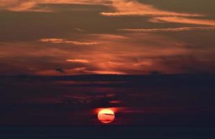 Colorful orange clouds and dark sky at sunset photo