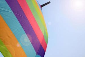 Rainbow umbrella against sky photo