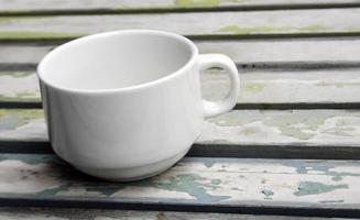 Coffee cup on rustic table photo