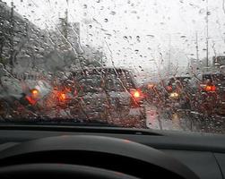 Car lights on rainy windshield photo