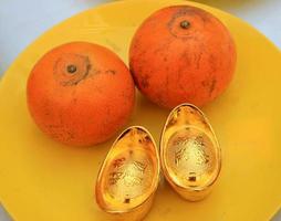 Oranges and gold ingots photo