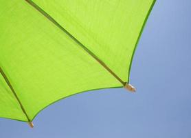 Green umbrella and blue sky photo