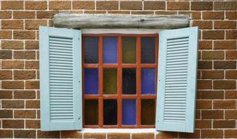 Blue shutters on stained glass window photo