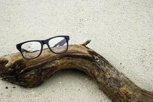 Glasses on driftwood photo