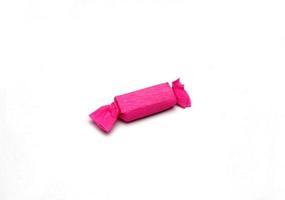 Pink taffy candy on a white photo