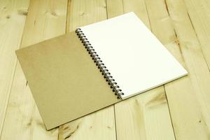 Open blank notebook on table photo