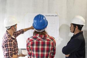 Asian engineers with hard hats on photo