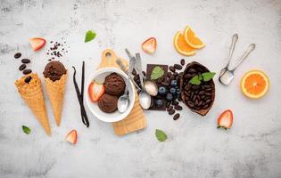 Chocolate ice cream flavours in bowl with dark chocolate and cacao nibs photo