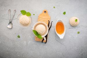 Vanilla ice cream flavor in bowl with vanilla pods