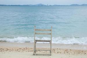 White wooden chair at the sea photo