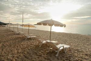 Sunbathing beds and umbrellas photo