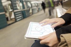 Person looking at a map on a tablet photo