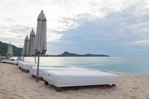 Chairs on the beach in Thailand photo