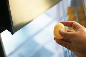Person grabbing an egg from refrigerator photo