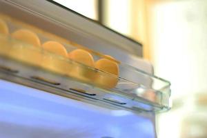 Eggs on shelf of refrigerator photo