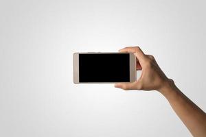 Hand holding a smartphone isolated on white background photo