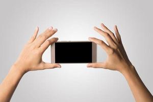 Hand holding a smartphone isolated on white background photo