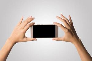 Hand holding a smartphone isolated on white background photo