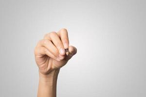 Woman's hand holding a pen isolated on white background photo