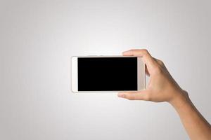 Hand holding a smartphone isolated on white background photo