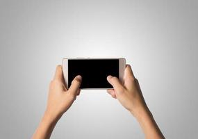 Hand holding a smartphone isolated on white background photo