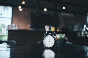 Retro alarm clock on a wooden table photo