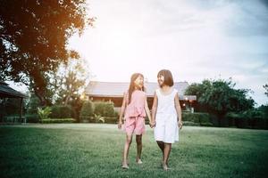 Two little girls having fun playing in the park photo