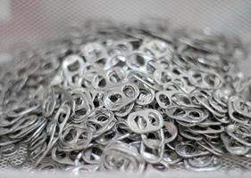 Pile of aluminum can tabs photo
