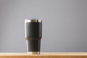 Black thermos on table photo