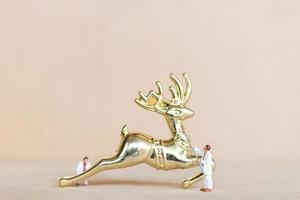 Miniature people working on Christmas decorations photo