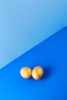 Two gold eggs on blue photo