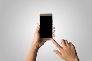 Hand holding a smartphone isolated on white background photo