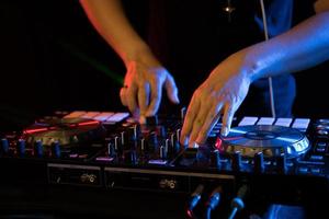 DJ playing turntable music on night club party photo