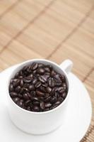 Roasted coffee beans in a cup photo