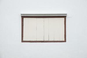 Old window on a white wall photo
