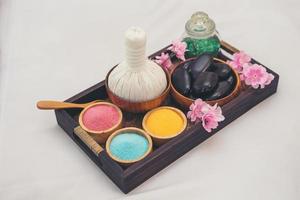 Essential oils, bath salts and black massage hot stones photo