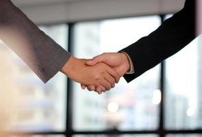 Close-up of a handshake in an office photo