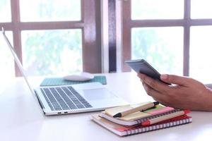 Worker using phone at desk photo