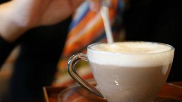 Closeup of lady preparing and eating hot chocolate coffee cup video